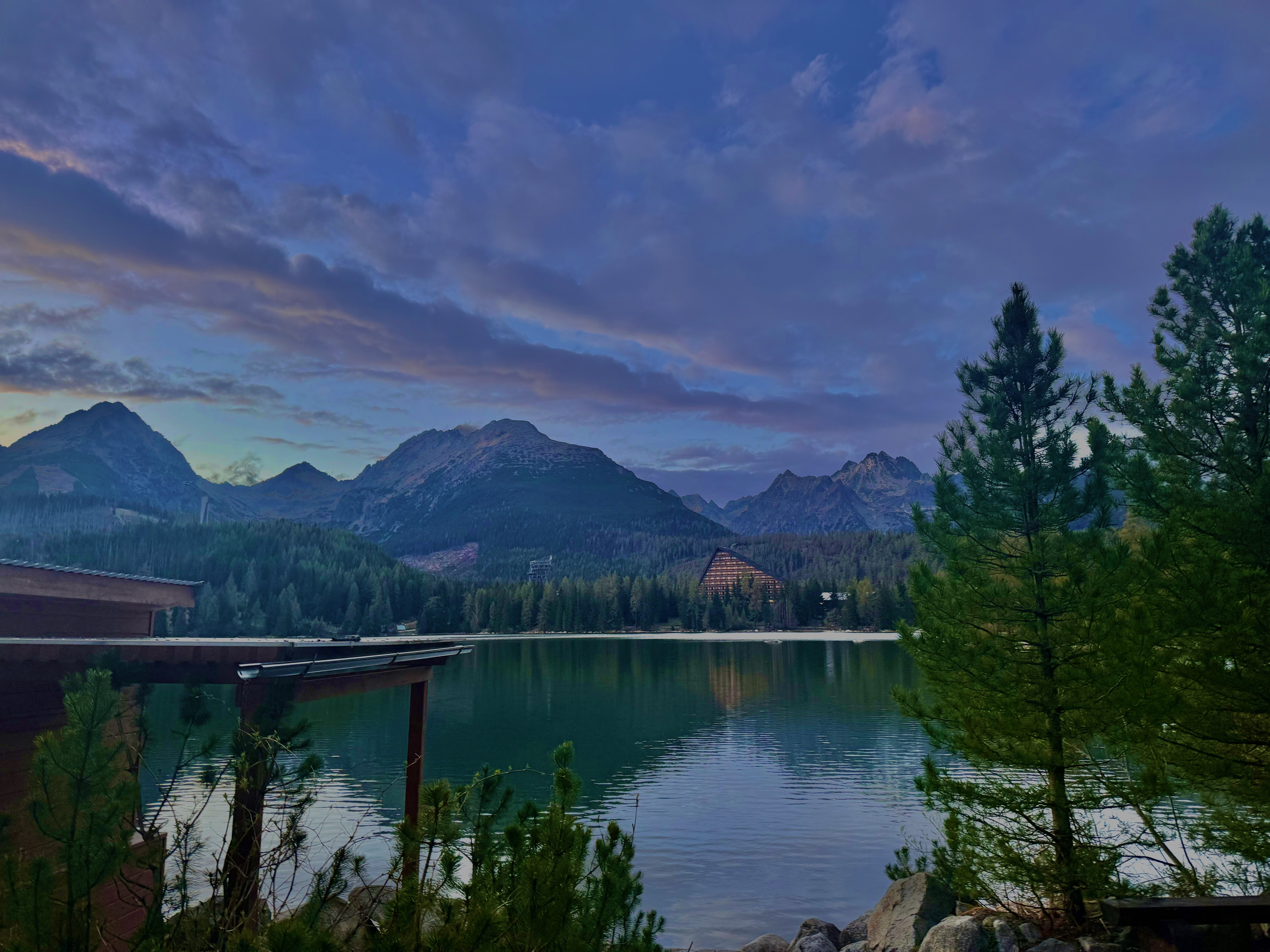 Mountain lake at twilight in the High Tatras, still water reflecting peaks and violet sky
