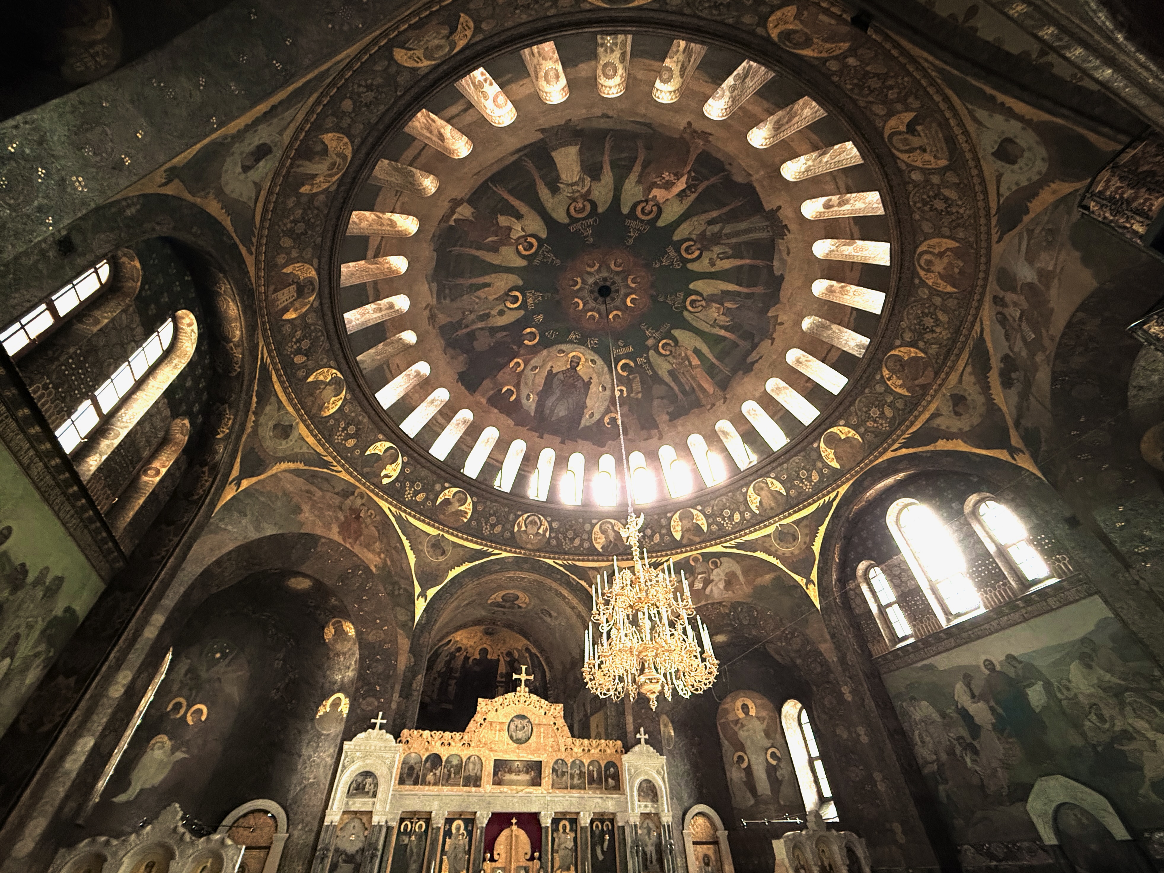 Frescoed dome and golden chandelier inside an Orthodox cathedral