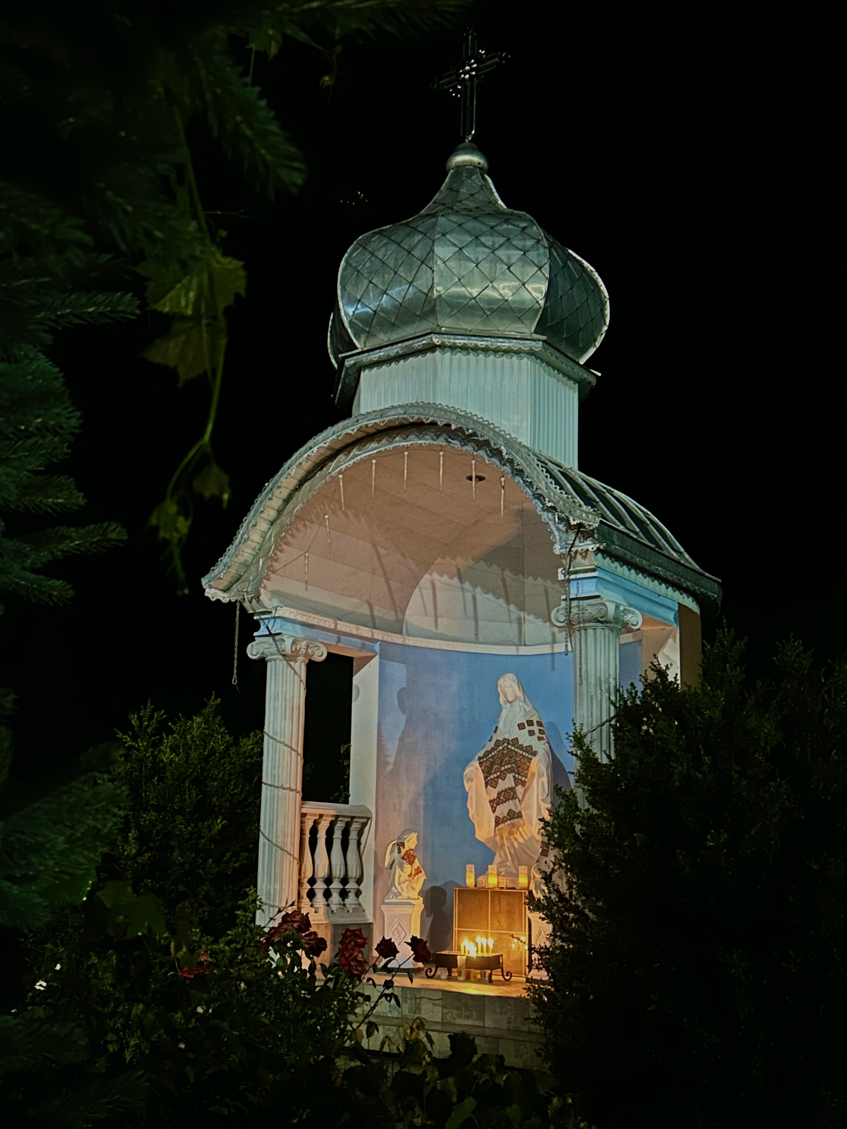 Illuminated shrine with silver dome at night, Verkhovyna, Ukraine