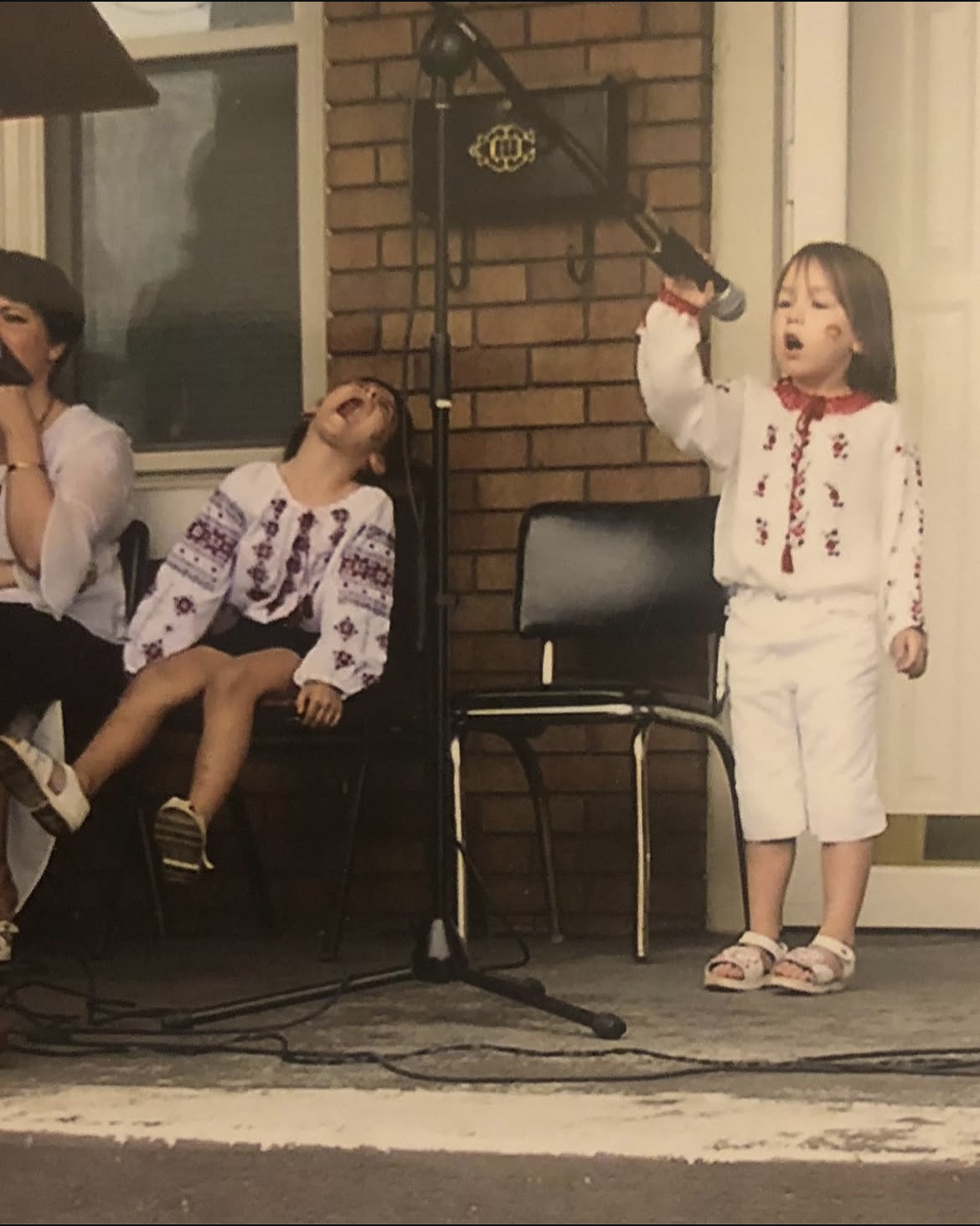 Young Sophia singing at a microphone