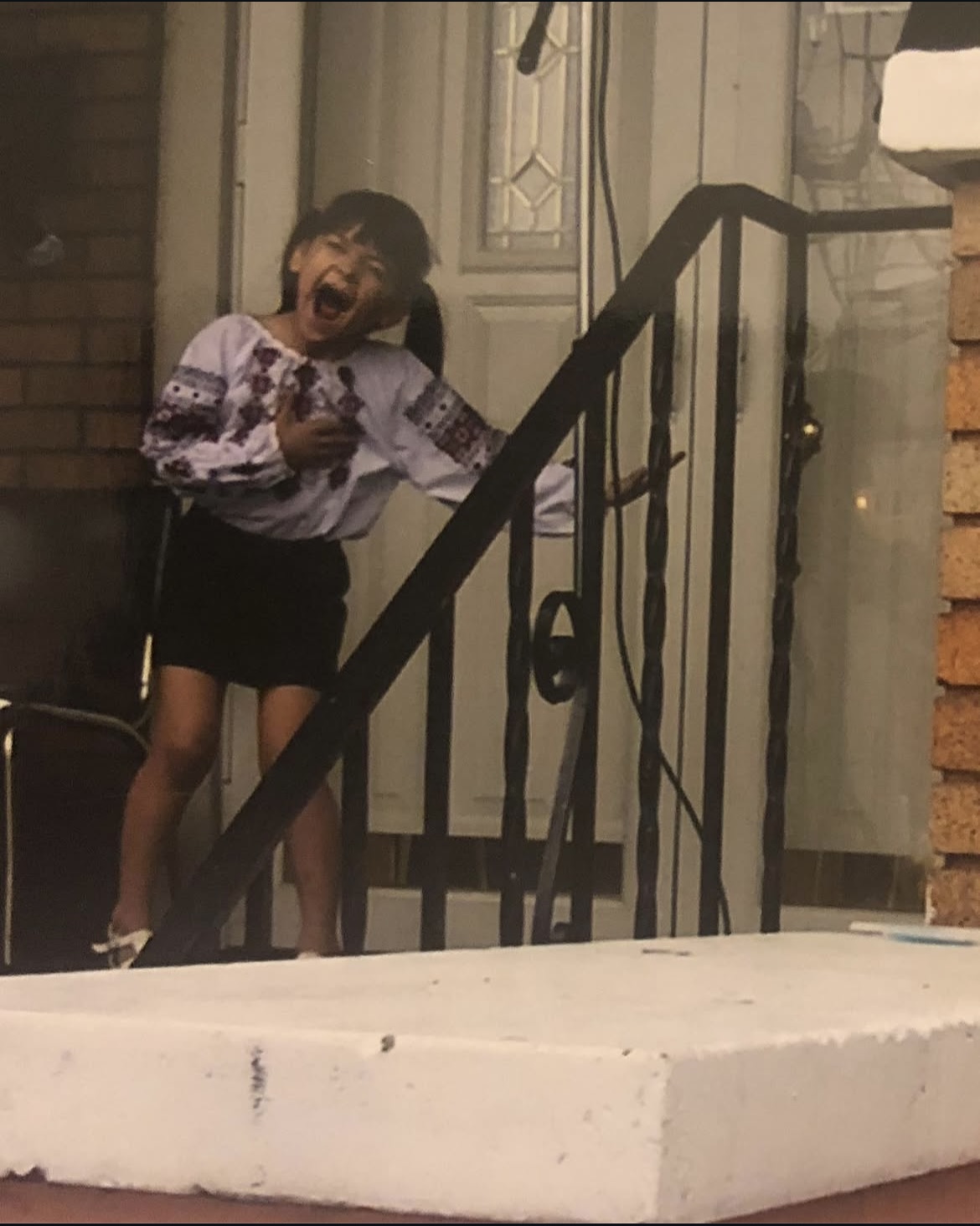 Young Sophia on the porch in a vyshyvanka