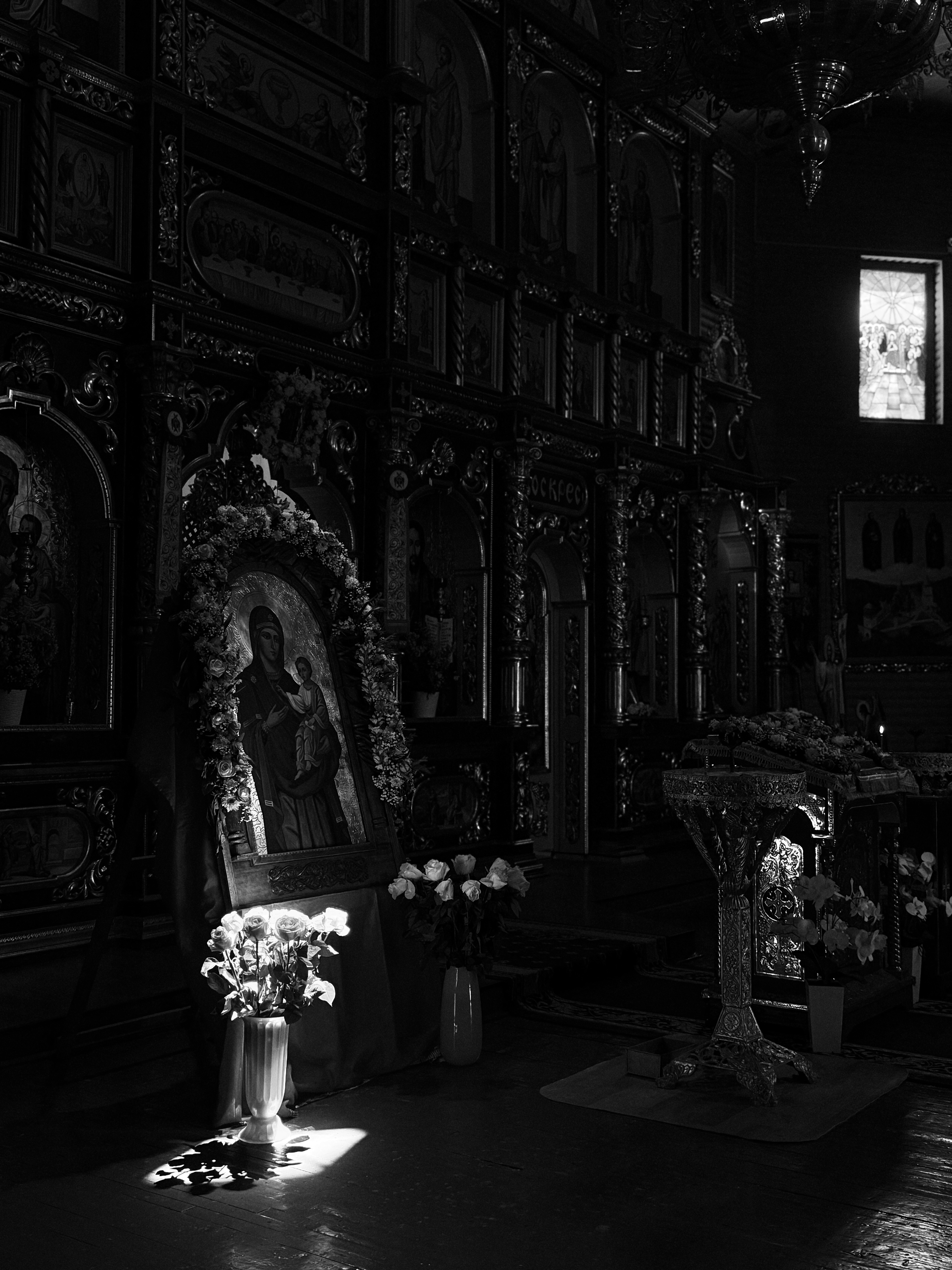 Iconostasis in a Ukrainian church, flowers lit by a shaft of light