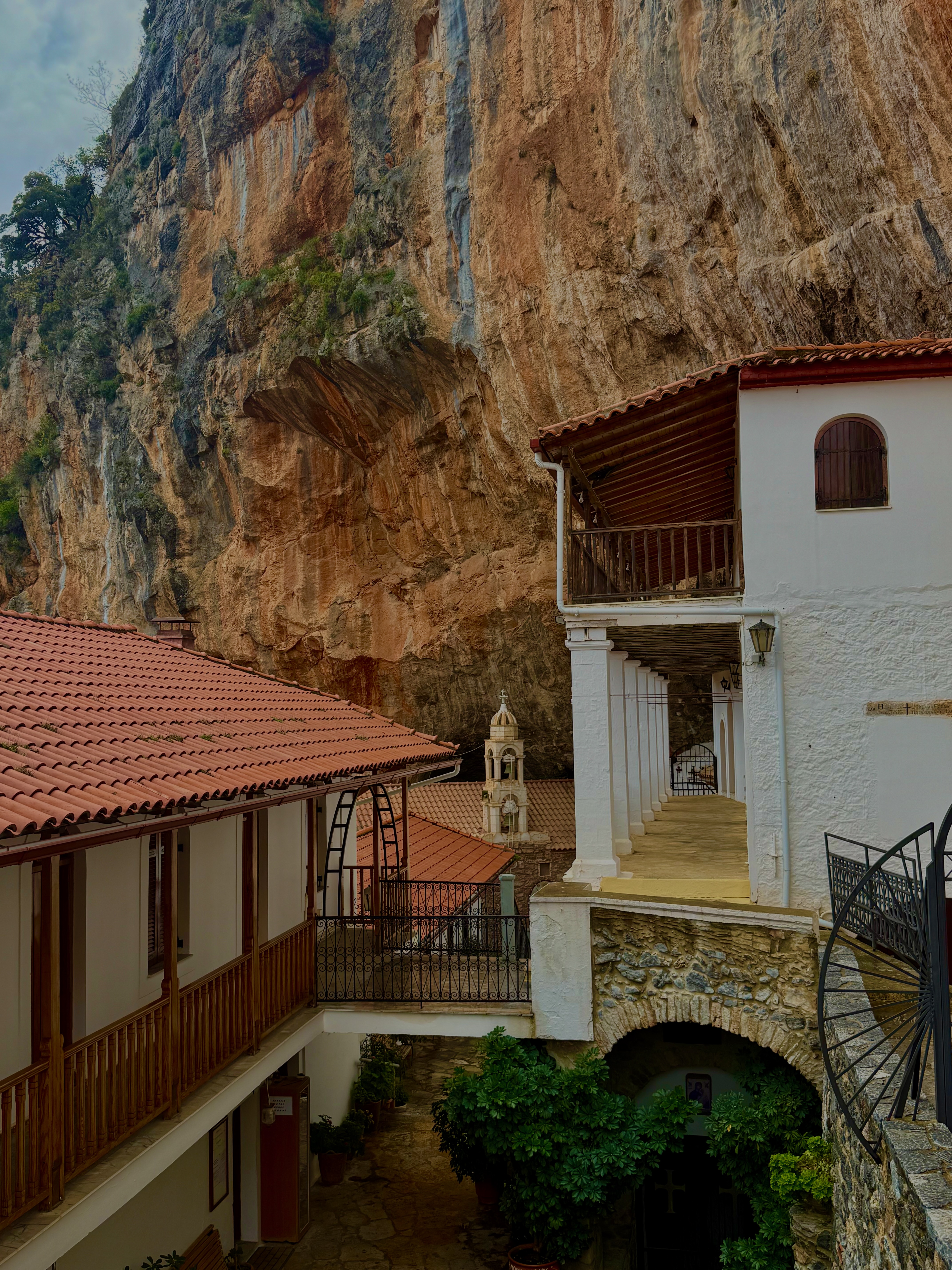 Monastery built into a cliff face with terracotta roofs